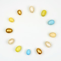 Circle of Easter Eggs over a white background. Simple, modern minimalist concept. Copy space.