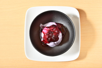 Blueberry ice cream in a black bowl