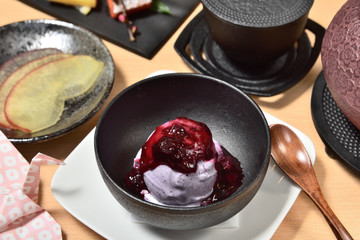 Blueberry ice cream in a black bowl