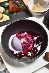 Blueberry ice cream in a black bowl