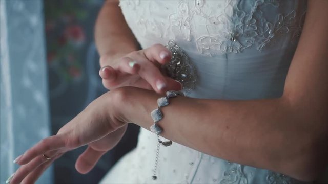 The bride wears wedding jewelry, put bracelet on wrist. Clip. Bride bracelet, jewelry bracelet on the brides hand