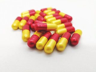 Medication and healthcare concept. Many red-yellow capsules of Amoxicillin500 mg. isolated on white background, used to treat many different types of infection caused by bacteria. copy space.