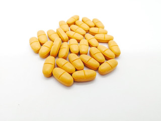 Medication and healthcare concept. Many orangeg tablets of Ibuprofen 400 mg. combined with Paracetamol 500 mg. isolated on white background, used to treat muscle inflammation and reduced pain. 