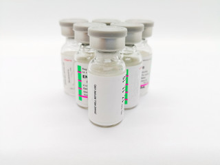 Medication and healthcare concept. Many transparent vials of injectable contraceptive,  isolated on white background, used for birth control. Focus on foreground and copy space.