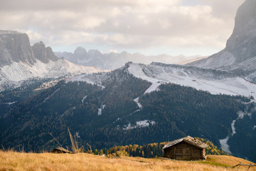 Fototapeta na wymiar Wooden cottage in dolomities alps Italy