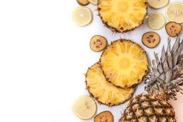 slices of pineapple, feijoa and lemon on a white background