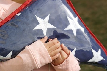Small Hands Holding Folded American Flag 3