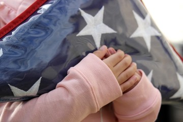 Small Hands Holding Folded American Flag 2