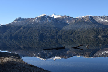 Splendid and calm day in Lake Traful, Patagonia Argentina. Beautiful landscape with mountains reflected in the lake on a sunny day.
