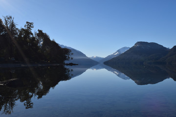 Splendid and calm day in Lake Traful, Patagonia Argentina. Beautiful landscape with mountains reflected in the lake on a sunny day.