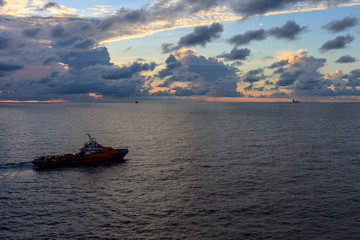 Offshore oil and gas crew boat approach to the platform for transfer passenger between crew boat...