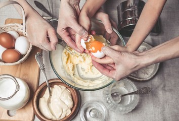 Mothers and children's hands cook dough for home-made cookies. Happy family concept