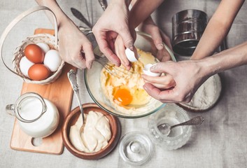 Mothers and children's hands cook dough for home-made cookies. Happy family concept