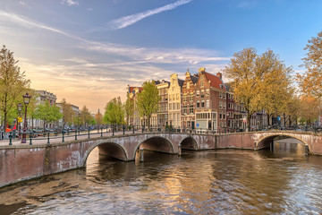 Amsterdam sunset city skyline at canal waterfront, Amsterdam, Netherlands