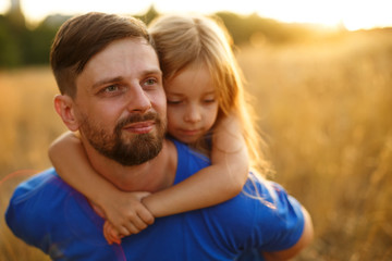 Obraz premium Father carries a daughter piggyback