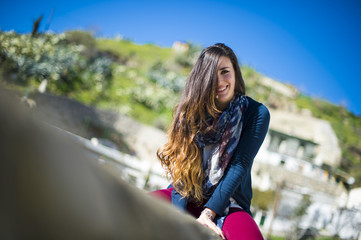 Young beautiful girl smiling cheerfully at you.