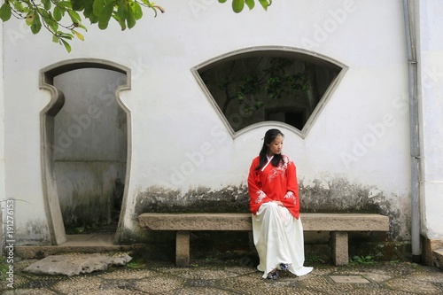 A Young Woman In Red Chinese Costume Sitting A Young Woman In Red Chinese Costume Sitting Traditional Patio Front