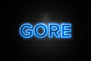 Gore neon Sign on brickwall