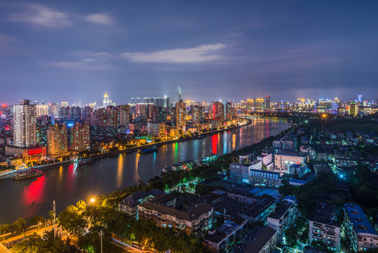 Illuminated city near river by night, Shanghai, China