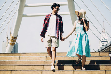 Couple Asian travelers are walking and enjoying vacations on city street. Travel concept