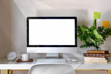 Mockup desktop computer, coffee mug, plant and accessories on desk, Workspace and blank screen desktop computer.