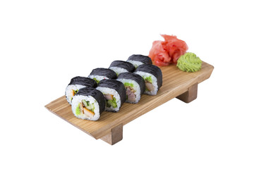 Sushi set on a wooden board, isolated.