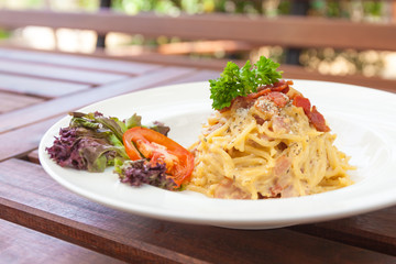 Spaghetti with bacon white cream sauce.