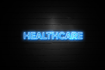 Obraz premium Healthcare neon Sign on brickwall