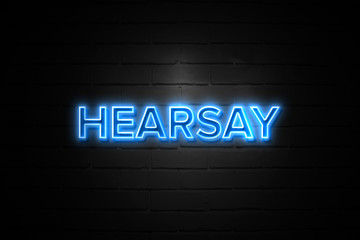 Hearsay neon Sign on brickwall