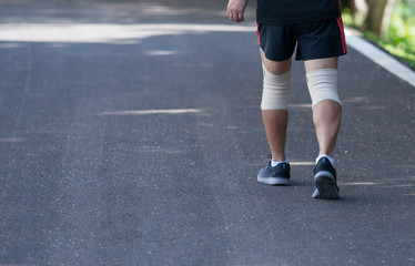 Close up of knee support brace on leg at public park