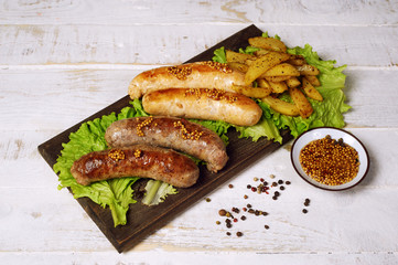 Meat fried sausages on a wooden table