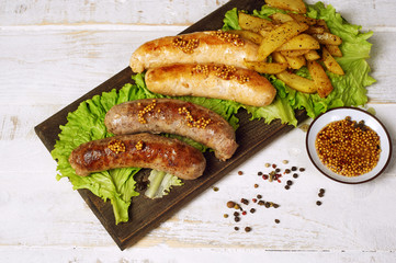 Meat fried sausages on a wooden table