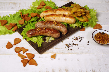 Meat fried sausages on a wooden table