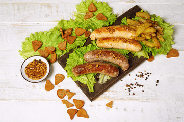 Meat fried sausages on a wooden table