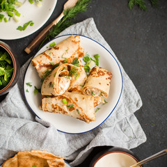 Pancakes with meat, herbs and sour cream - traditional for Russian pancake week Maslenitsa - spring festival. Happy Shrove Tuesday
