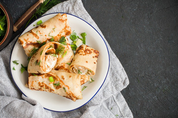 Pancakes with meat, herbs and sour cream - traditional for Russian pancake week Maslenitsa - spring festival. Happy Shrove Tuesday