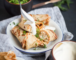 Pancakes with meat, herbs and sour cream - traditional for Russian pancake week Maslenitsa - spring festival. Happy Shrove Tuesday