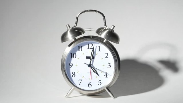 Twin Bell Silver Alarm Clock Ringing Loud Isolated on White, 4K
