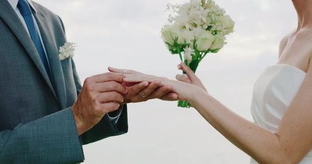 Bride and groom exchanging rings on wedding day