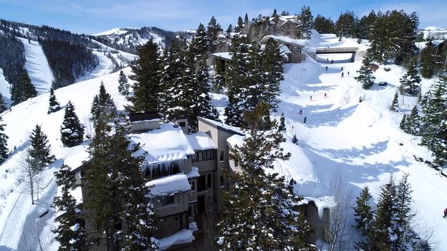 Aerial shot of people skiing in a high mountain resort