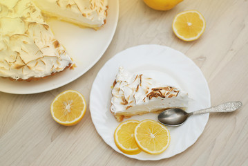 Piece of Lemon Cake with Meringue Cake. Lemon Fruits over Wooden Table. Birthday or Party Dessert.