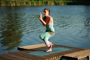 Fototapeta na wymiar Woman do yoga outdoor. Woman exercising vital and meditation for fitness lifestyle club at the nature background. Concept Yoga