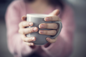 Woman holding coffee mug
