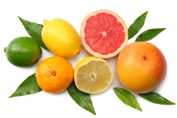 healthy food. mix sliced lemon, green lime, orange, mandarin, kiwi fruit and grapefruit with green leaf isolated on white background. top view