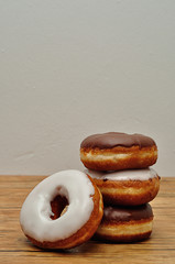 A stack o doughnuts on a wooden table