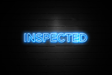 Inspected neon Sign on brickwall