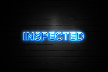 Obraz premium Inspected neon Sign on brickwall
