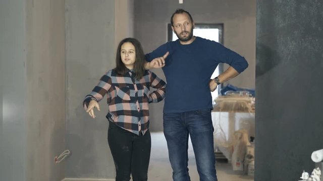 Father with daughter talking about project at their new apartment
