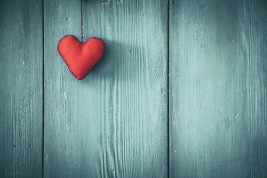 Red heart shape, wooden background