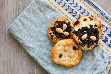 Three Yeast cake with almond, poppy, raisin, and cheese on towel